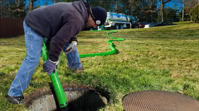 Service technician performing residential septic pumping and drainage maintenance in Oklahoma City, OK